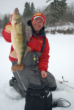Jeff 'Gussy' Gustafson hoists a chunky first ice walleye that couldn't resist a Buckshot Rattle Spoon.